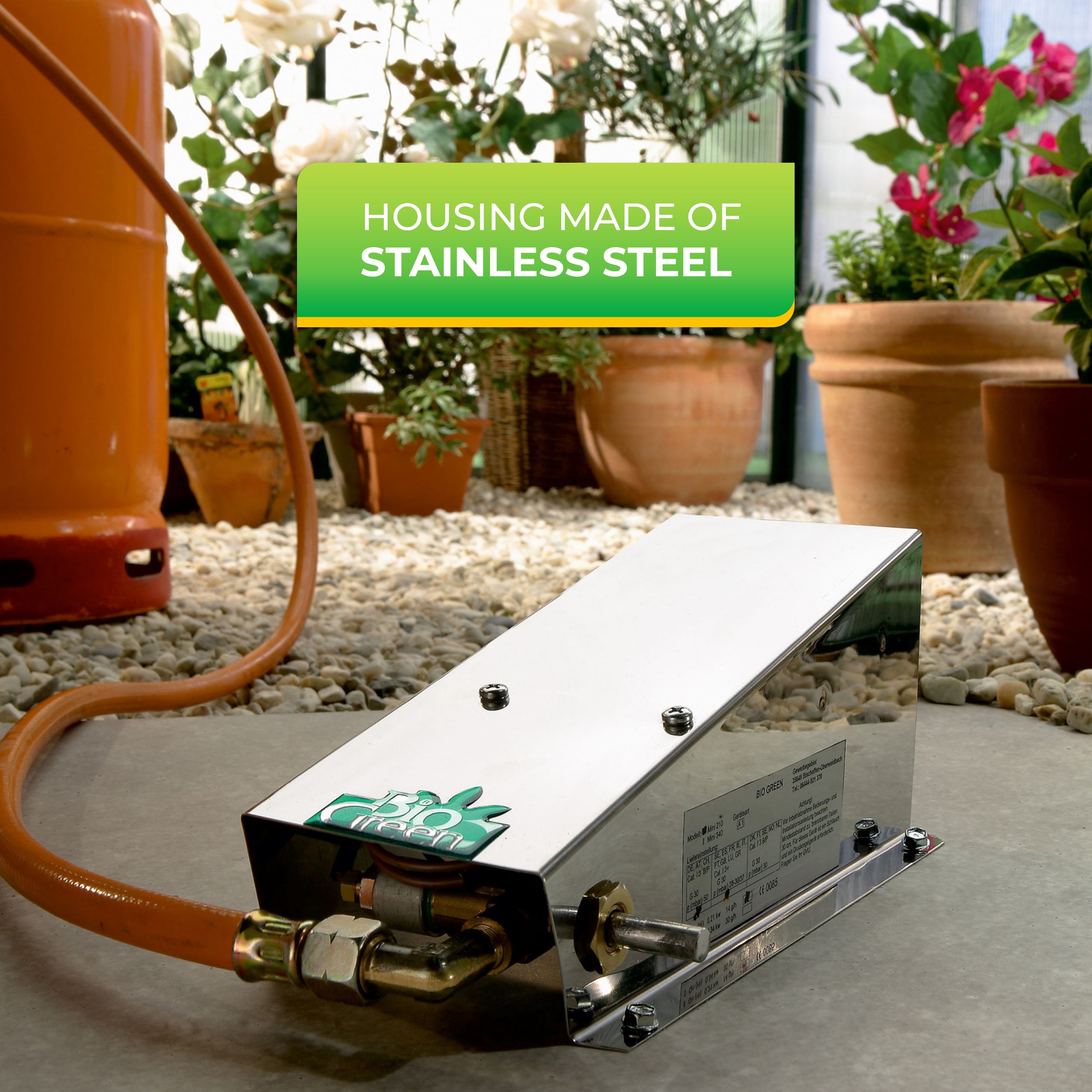 "Propane-powered heater with housing made of stainless steel, showcasing the gas connection and surrounded by potted plants."