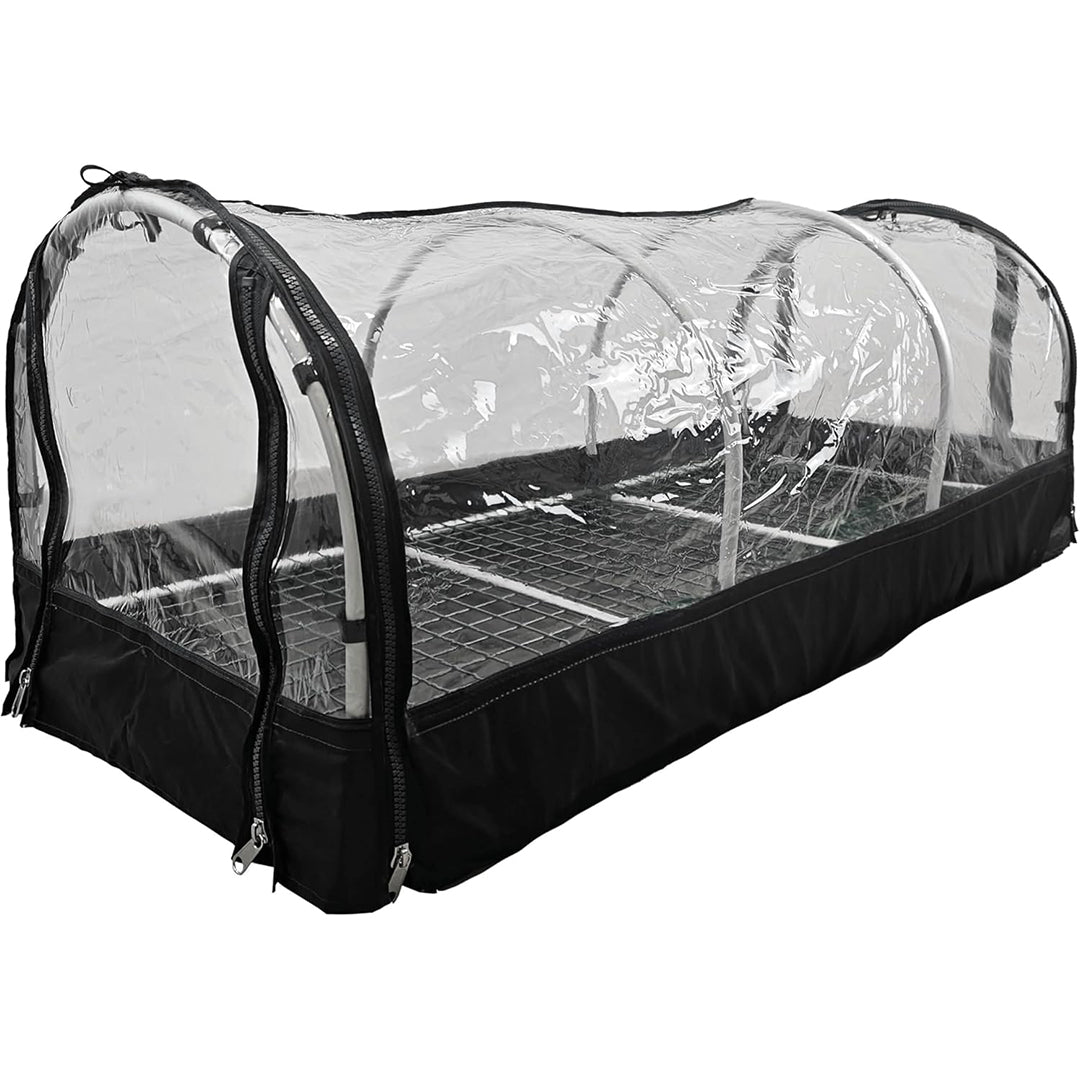 "Portable greenhouse with a transparent plastic cover, zippered sides, and a metal shelving unit inside. The structure is designed for plant propagation and protection."
