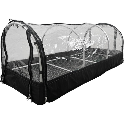 "Portable greenhouse with a transparent plastic cover, zippered sides, and a metal shelving unit inside. The structure is designed for plant propagation and protection."