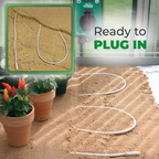 The image shows a flexible soil heating cable neatly laid out in a curved pattern, ready to be plugged in for use. The setup is designed to warm the soil, promoting healthy plant growth. A visible "Thermo2" thermostat is also shown, indicating that the system is ready to operate and regulate the temperature for optimal plant care.